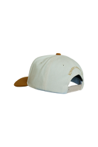 White cap with ochre visor on a white background